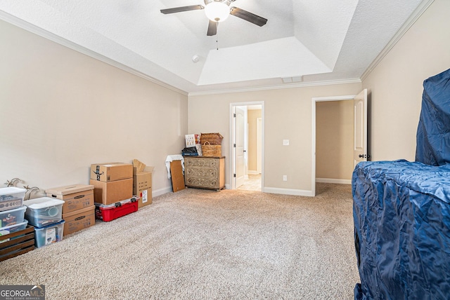 bedroom with crown molding, a raised ceiling, baseboards, and carpet