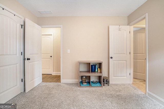 bedroom featuring baseboards, carpet, and visible vents