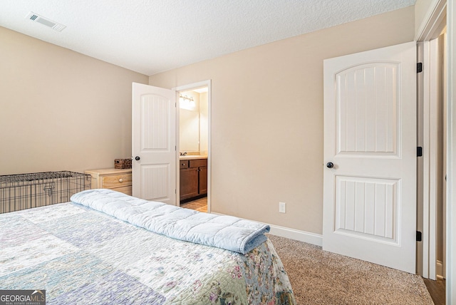 bedroom with baseboards, visible vents, and light carpet