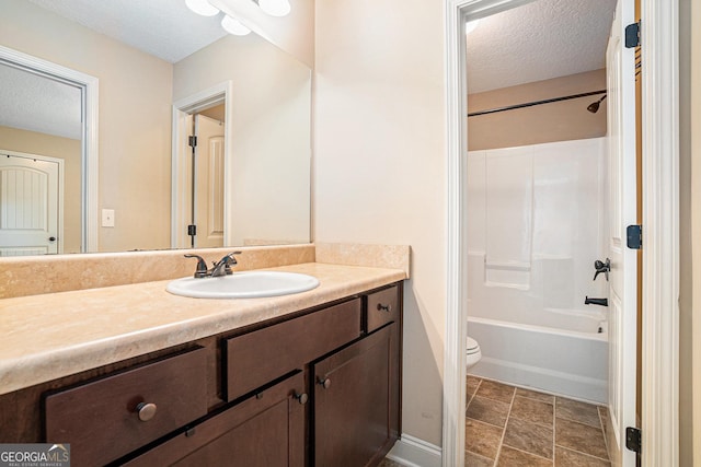 bathroom featuring vanity, a textured ceiling, bathtub / shower combination, and toilet