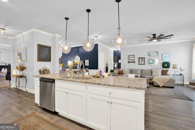 kitchen featuring stainless steel dishwasher, dark wood-style flooring, baseboards, open floor plan, and a sink