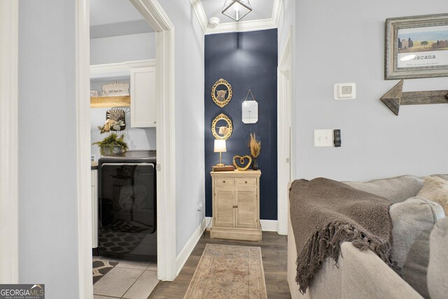bedroom with crown molding, baseboards, and wood finished floors