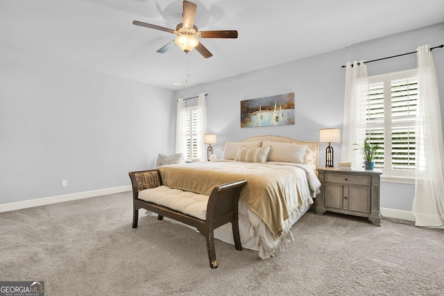 bedroom with baseboards, light carpet, and multiple windows