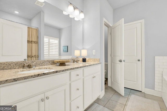 bathroom with visible vents, a sink, tile patterned floors, and toilet