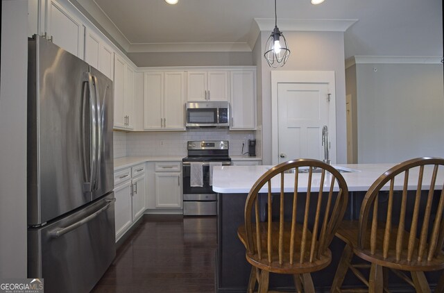 4143 N Swann St, Covington, GA 30014 - kitchen featuring light countertops, decorative backsplash, white cabinets, and stainless steel appliances
