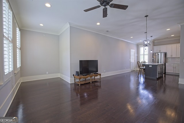 4143 N Swann St, Covington, GA 30014 - living room featuring ornamental molding, dark wood-style flooring, baseboards, ceiling fan, and recessed lighting