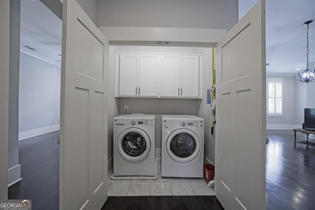 4143 N Swann St, Covington, GA 30014 - laundry room featuring crown molding, wood finished floors, baseboards, washing machine and clothes dryer, and cabinet space
