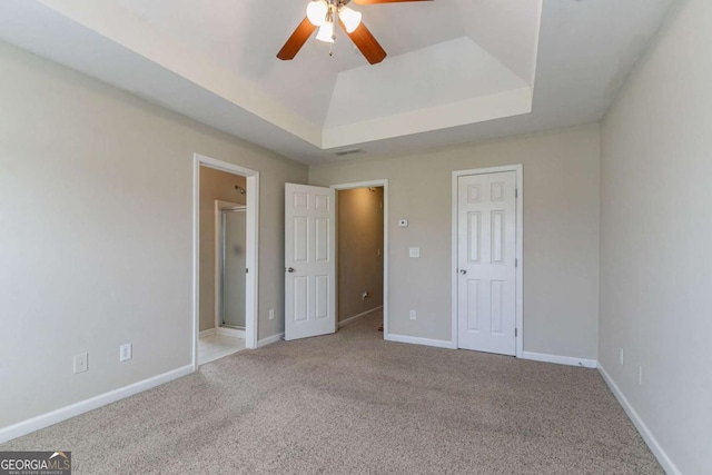 4870 Heather Mill Trce, Snellville, GA 30039 - unfurnished bedroom with a tray ceiling, carpet, ensuite bath, and baseboards