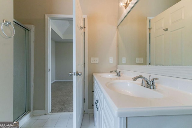 4870 Heather Mill Trce, Snellville, GA 30039 - bathroom with double vanity, a sink, tile patterned floors, baseboards, and a shower stall