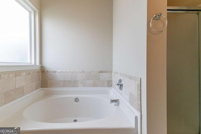 4870 Heather Mill Trce, Snellville, GA 30039 - bathroom featuring a bath and a shower stall