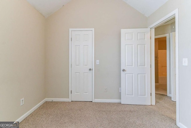 4870 Heather Mill Trce, Snellville, GA 30039 - unfurnished bedroom with lofted ceiling, baseboards, and carpet floors