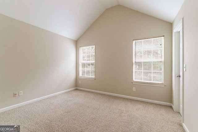 4870 Heather Mill Trce, Snellville, GA 30039 - spare room featuring light colored carpet, lofted ceiling, and baseboards