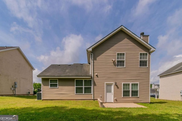 4870 Heather Mill Trce, Snellville, GA 30039 - back of property with a lawn, a patio area, and a chimney
