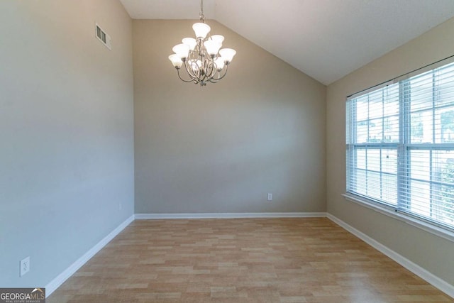 4870 Heather Mill Trce, Snellville, GA 30039 - spare room with an inviting chandelier, visible vents, baseboards, light wood-style floors, and lofted ceiling