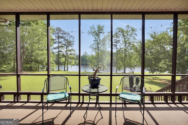 sunroom with a water view and a wealth of natural light