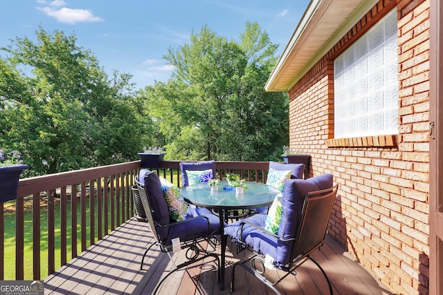 wooden terrace featuring outdoor dining space