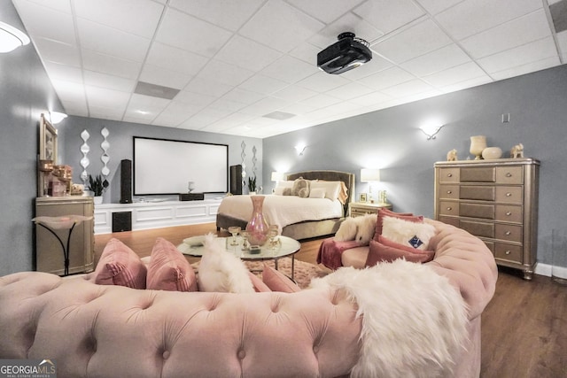 cinema with a drop ceiling and wood finished floors