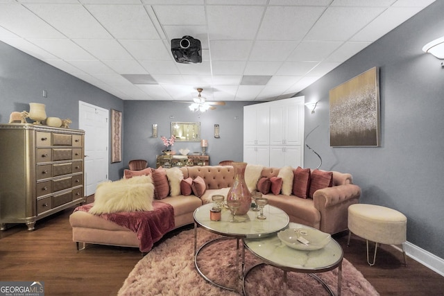 living room featuring a ceiling fan, baseboards, and dark wood-type flooring