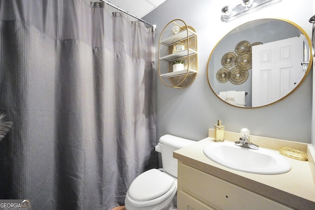 bathroom with toilet and vanity