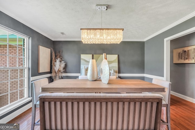 bedroom with wood finished floors, baseboards, radiator heating unit, a textured ceiling, and a chandelier