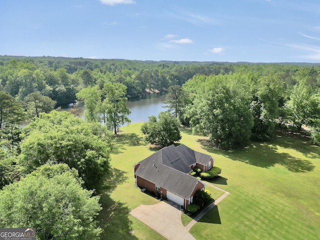 drone / aerial view featuring a forest view and a water view