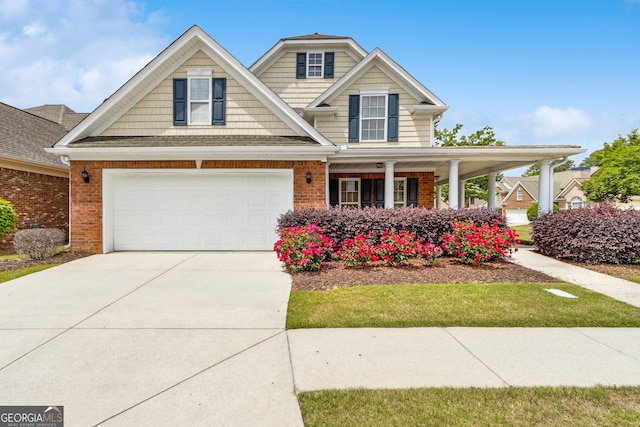 2055 Hickory Station Cir, Snellville, GA 30078 - craftsman house featuring brick siding, covered porch, and driveway