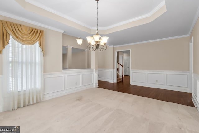 2055 Hickory Station Cir, Snellville, GA 30078 - unfurnished dining area with crown molding, wainscoting, a raised ceiling, carpet flooring, and a notable chandelier
