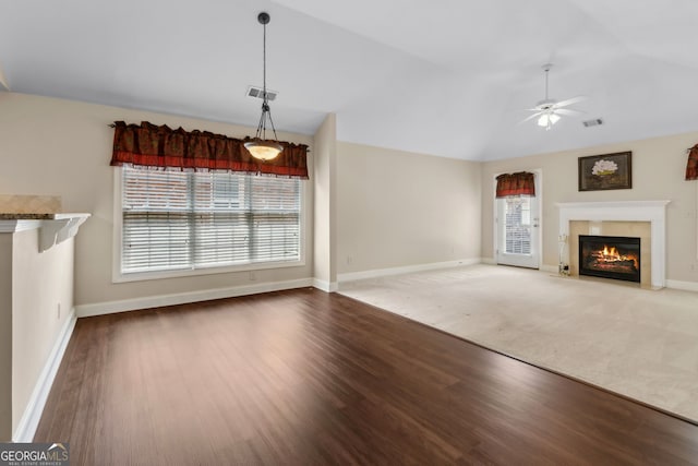2055 Hickory Station Cir, Snellville, GA 30078 - unfurnished living room with ceiling fan, a fireplace, wood finished floors, vaulted ceiling, and visible vents