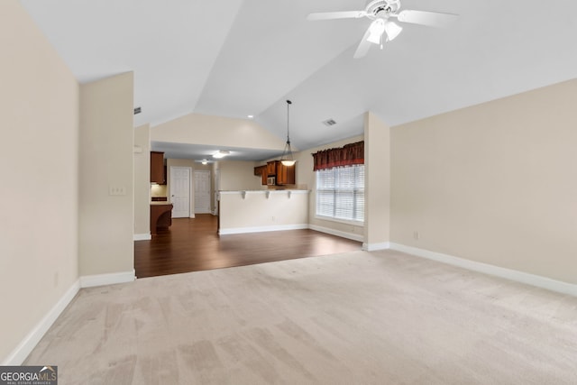 2055 Hickory Station Cir, Snellville, GA 30078 - unfurnished living room with carpet floors, ceiling fan, vaulted ceiling, and baseboards