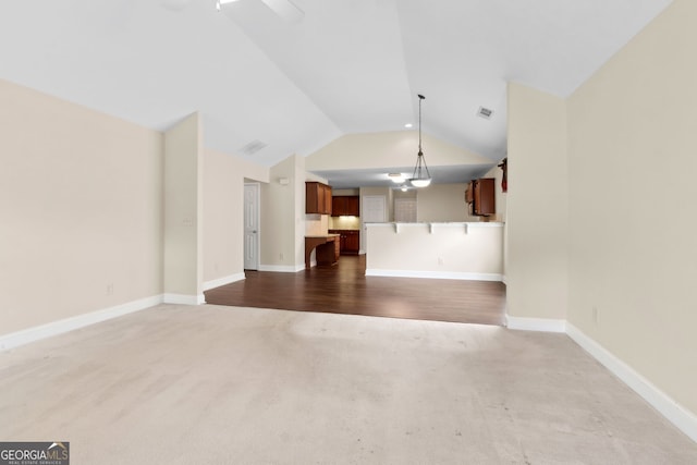 2055 Hickory Station Cir, Snellville, GA 30078 - unfurnished living room featuring baseboards, vaulted ceiling, dark carpet, and visible vents