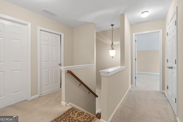 2055 Hickory Station Cir, Snellville, GA 30078 - hall featuring baseboards, visible vents, light colored carpet, and an upstairs landing