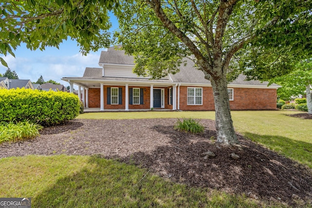 2055 Hickory Station Cir, Snellville, GA 30078 - traditional-style house with covered porch, a shingled roof, brick siding, and a front yard