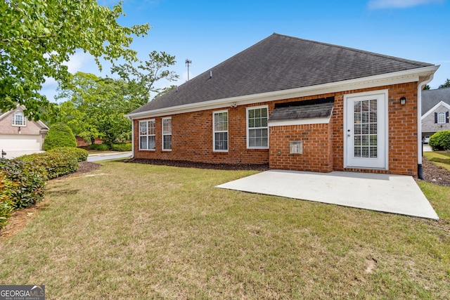 2055 Hickory Station Cir, Snellville, GA 30078 - back of property featuring roof with shingles, a lawn, a patio area, and brick siding