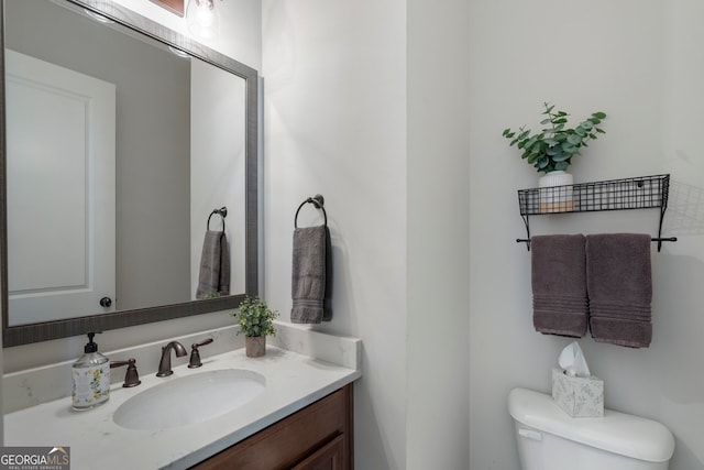 bathroom featuring toilet and vanity