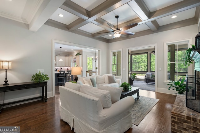 living area with healthy amount of natural light, coffered ceiling, a ceiling fan, beamed ceiling, and baseboards