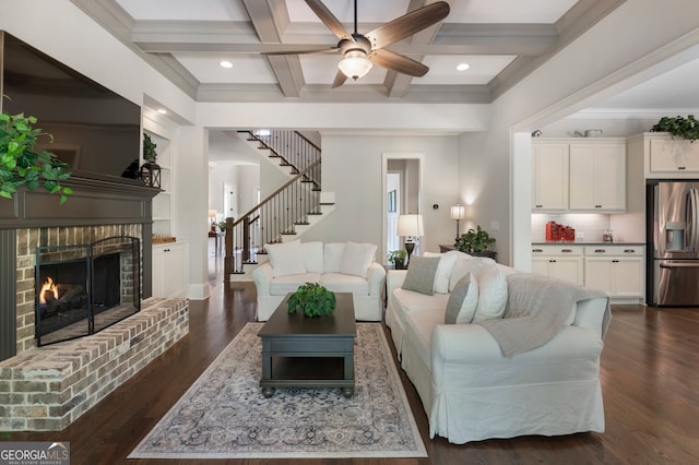 living room featuring coffered ceiling, stairway, beam ceiling, dark wood-type flooring, and a ceiling fan