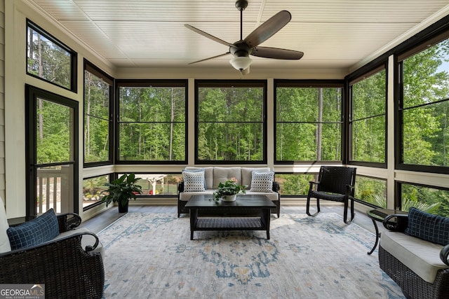 sunroom featuring ceiling fan, healthy amount of natural light, and outdoor lounge area