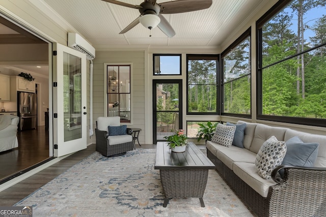 sunroom featuring ceiling fan, an outdoor living space, an AC wall unit, and french doors