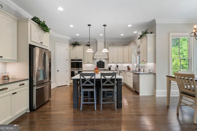 kitchen with stainless steel appliances, premium range hood, a sink, a kitchen island, and backsplash