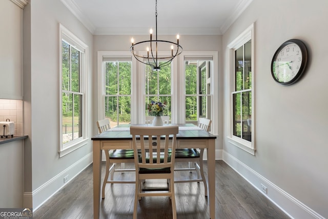 dining space with a chandelier, dark wood-type flooring, baseboards, and crown molding