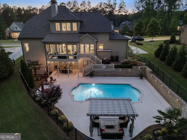 back of property featuring stairs, a patio area, roof with shingles, a wooden deck, and a chimney
