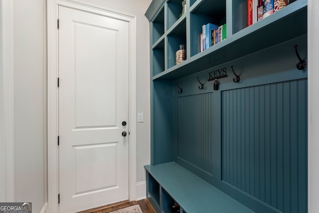 mudroom with dark wood finished floors