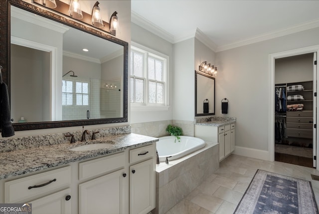 full bathroom featuring a stall shower, a bath, crown molding, two vanities, and a walk in closet