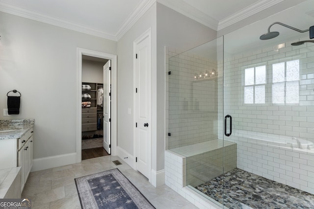 bathroom featuring a stall shower, baseboards, crown molding, vanity, and a spacious closet