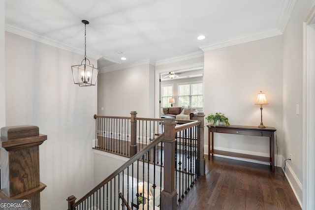 hallway with an upstairs landing, wood finished floors, recessed lighting, crown molding, and a chandelier