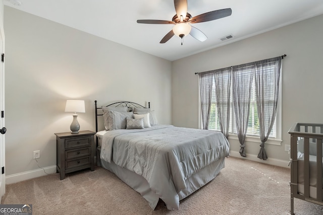 bedroom with baseboards, light colored carpet, and ceiling fan