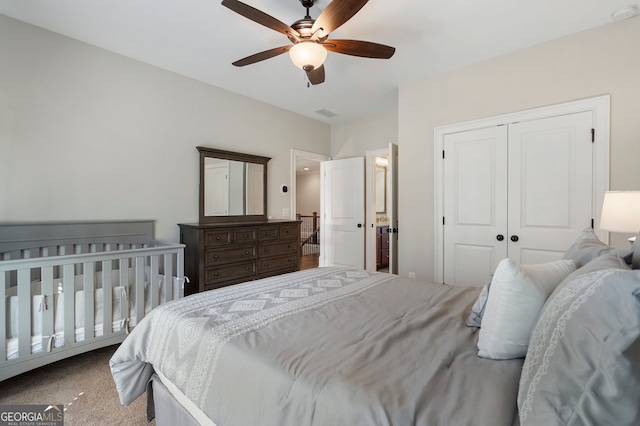 carpeted bedroom featuring a closet and a ceiling fan