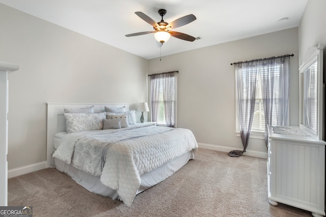 bedroom with carpet floors, baseboards, and a ceiling fan