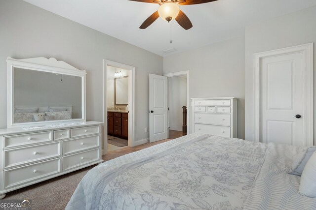 carpeted bedroom with connected bathroom, a ceiling fan, and baseboards