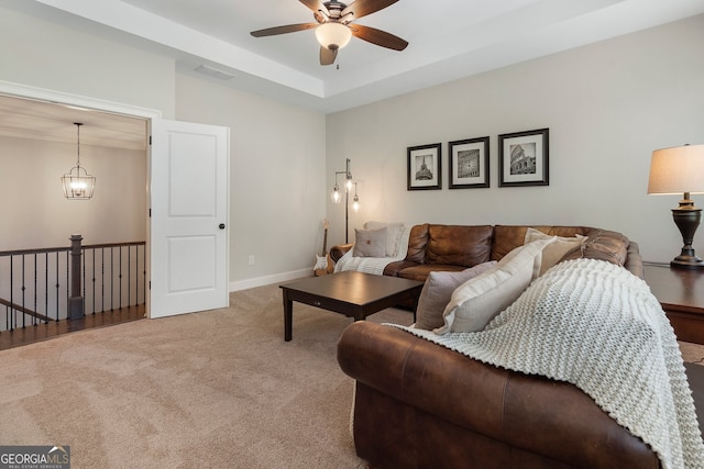 carpeted living room with ceiling fan and baseboards
